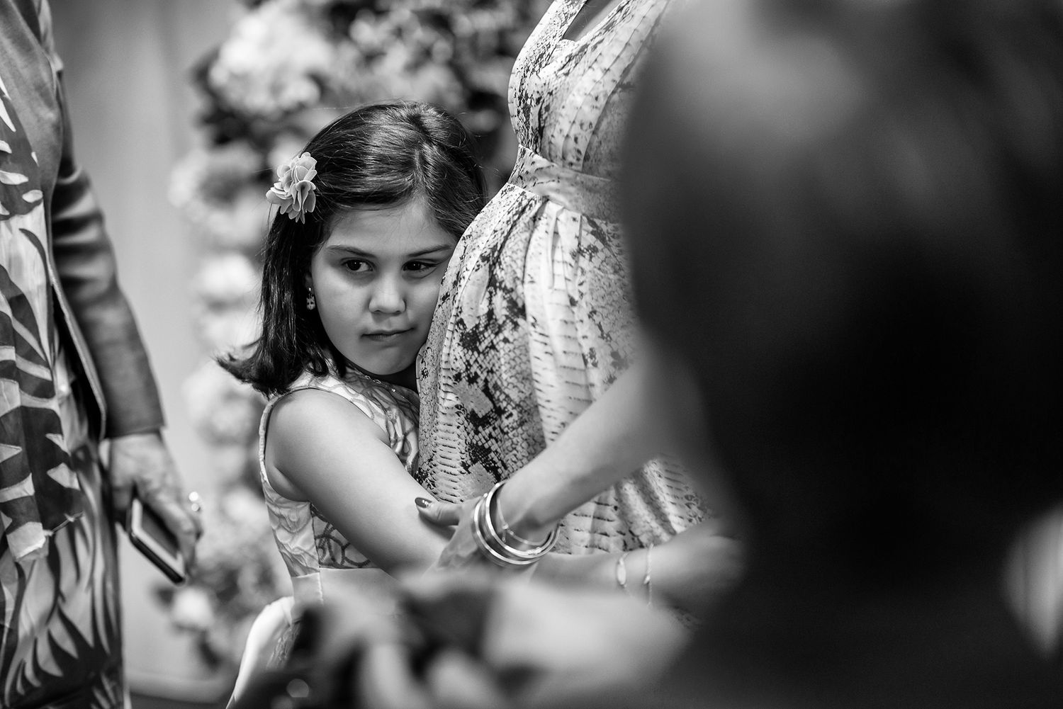 Candid black and white shots of wedding guests during emotional ceremony moments.