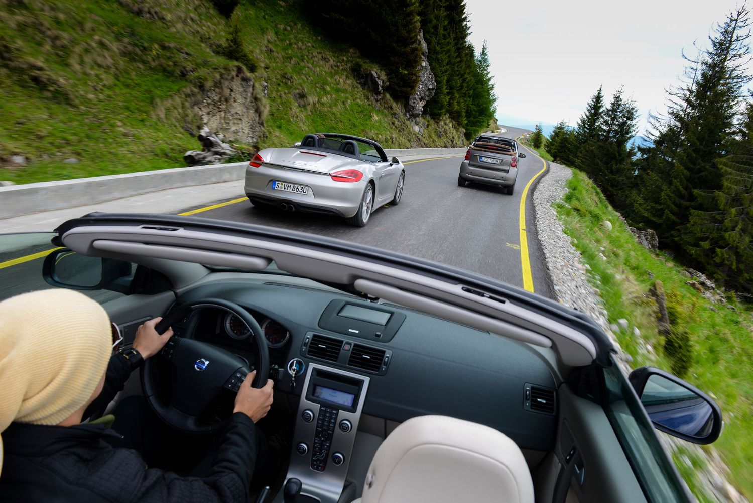 Series of car dashboard views while driving along a scenic mountain road.