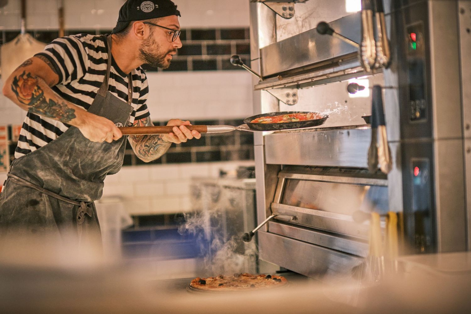 Close-up shots of hands preparing and plating food in a restaurant kitchen setting.