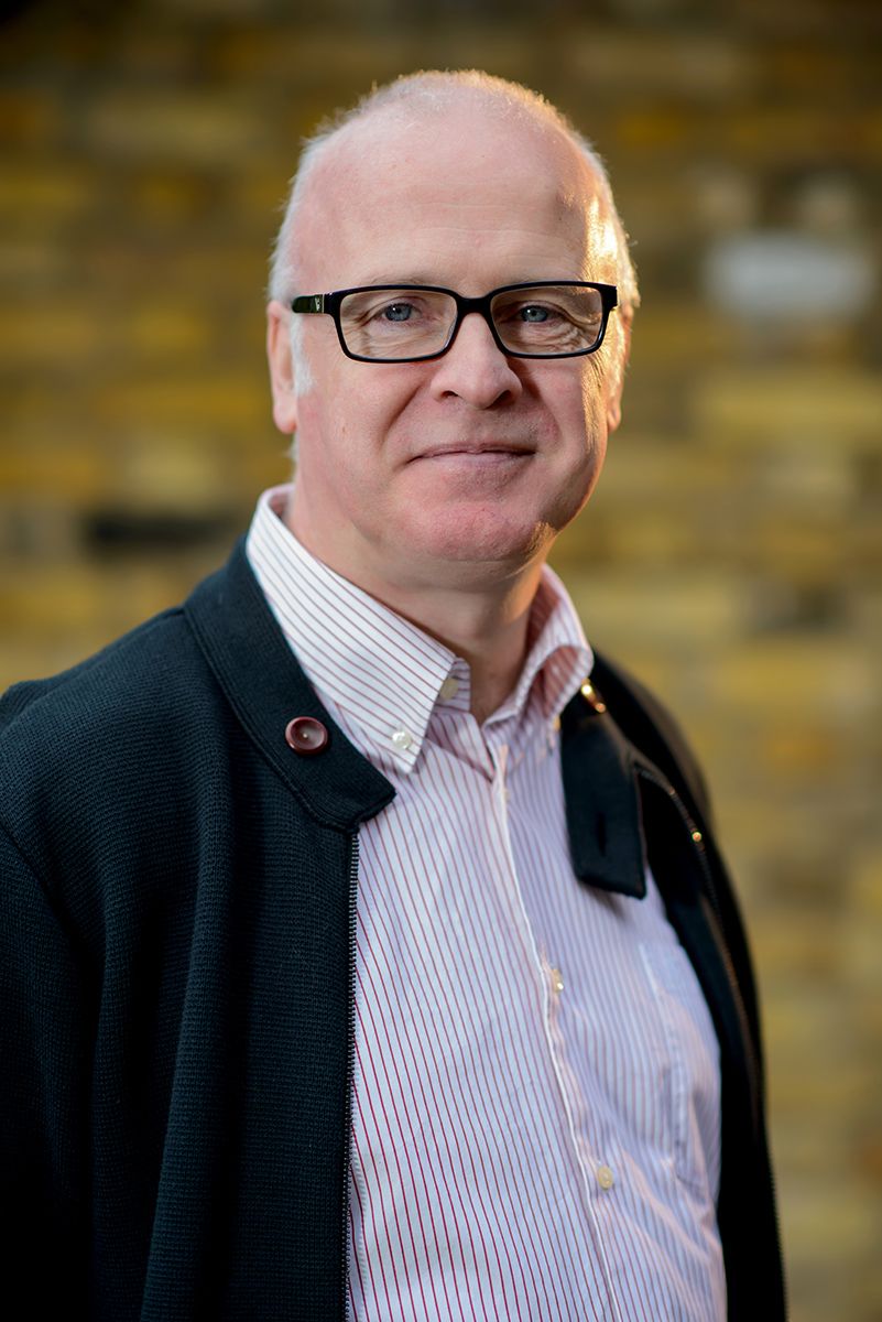 Close-up series of person in glasses and striped shirt against textured wall.