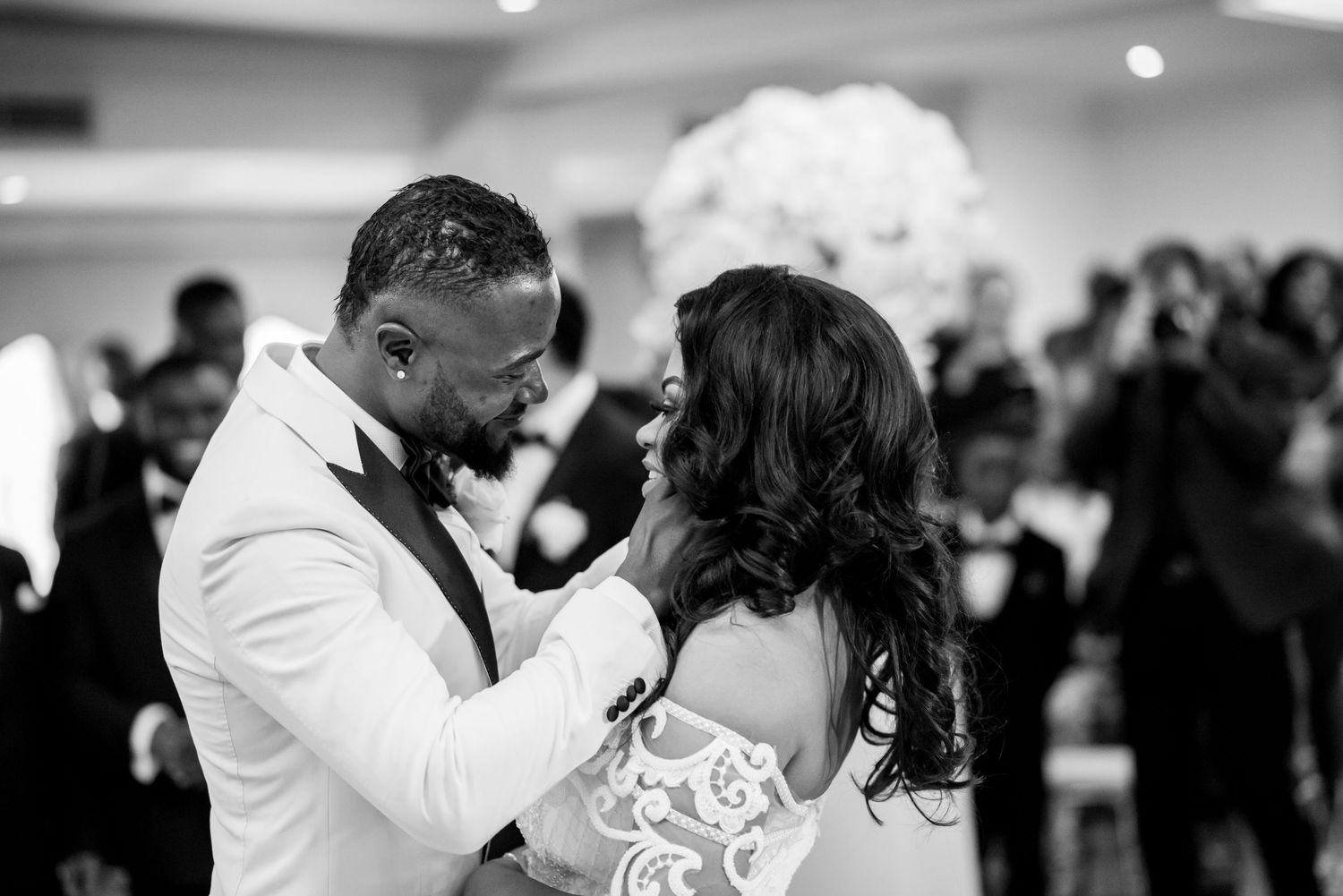 An elegant couple shares a romantic first dance at their wedding reception.