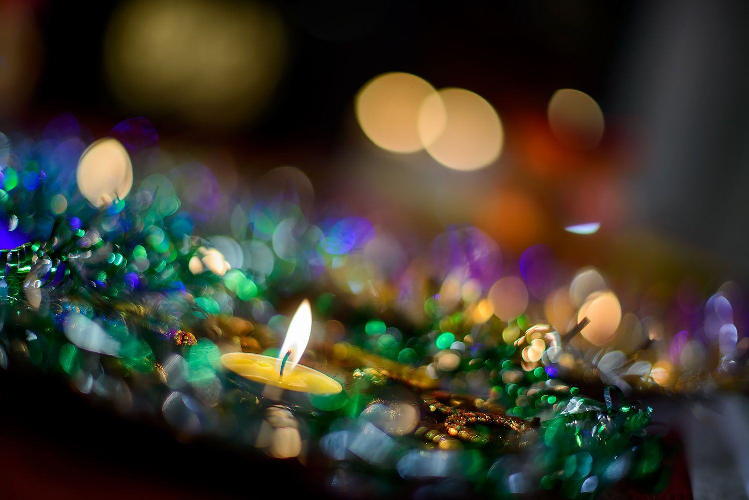 Bokeh lights creating a magical ambiance with green and gold sparkles.