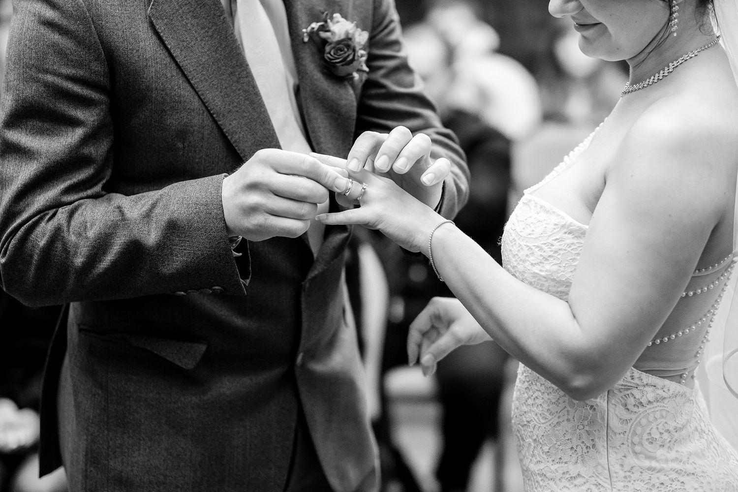 Intimate moments captured during wedding ceremony in black and white photography.