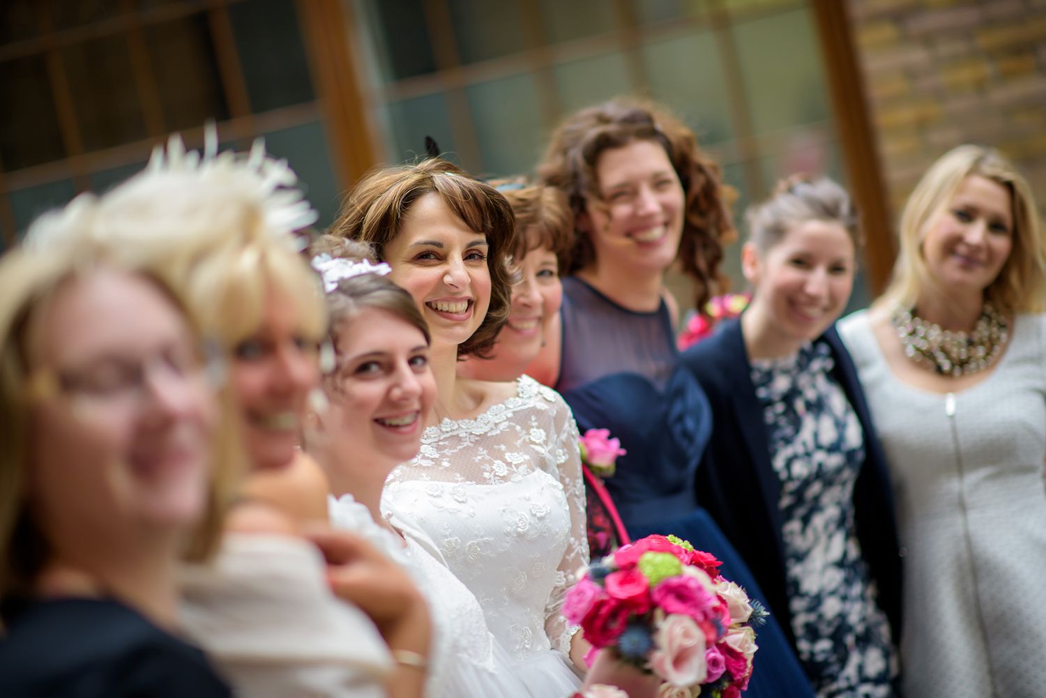 Wedding guests smile and gather during outdoor celebration ceremony.