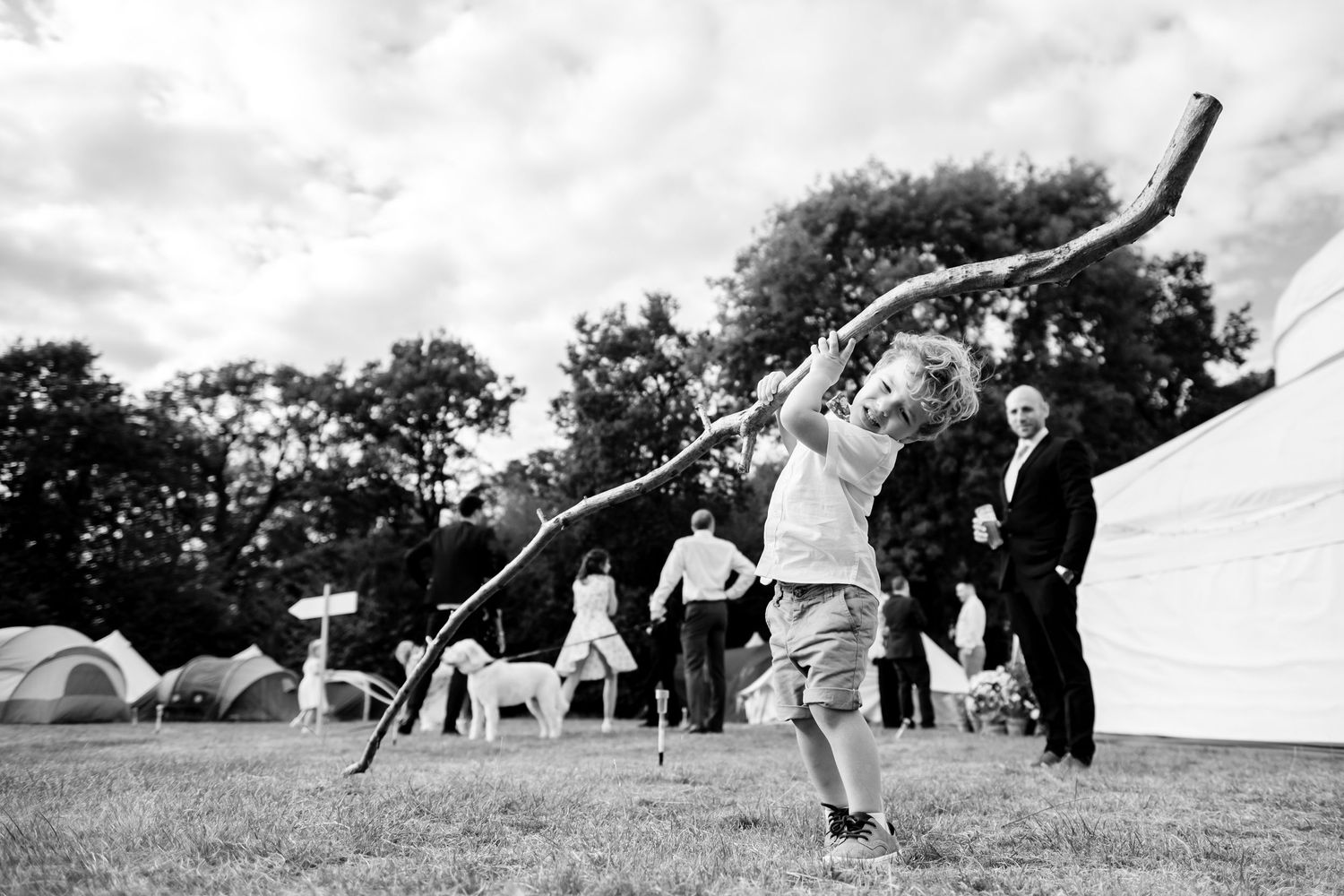 Wedding guests playing outdoor lawn games at a summer reception.