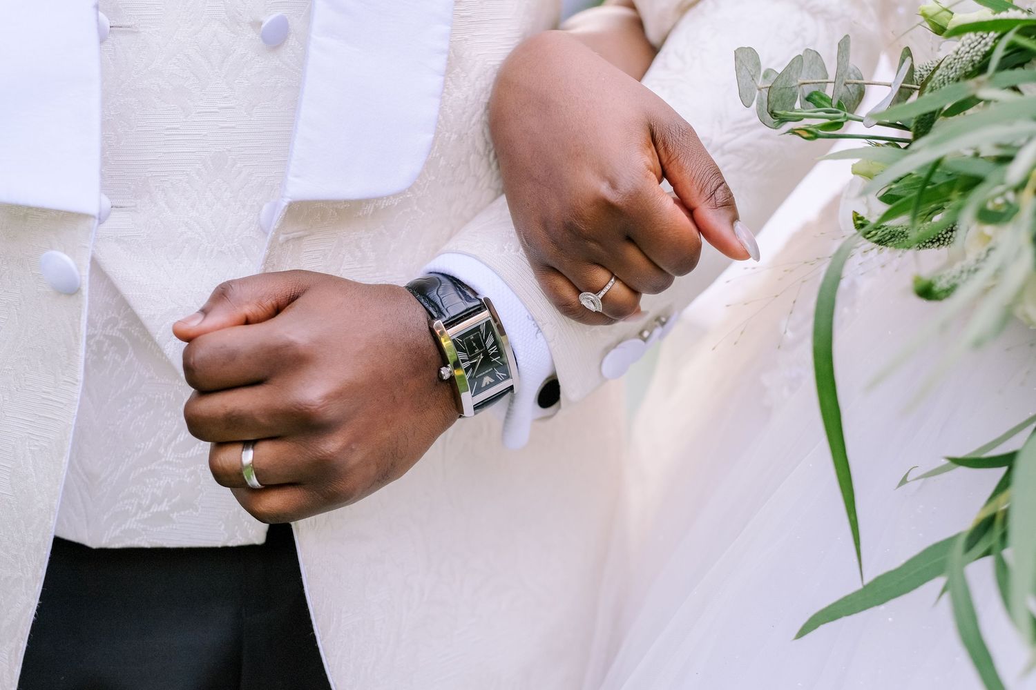 Detail shots of wedding attire and accessories in white and cream tones.