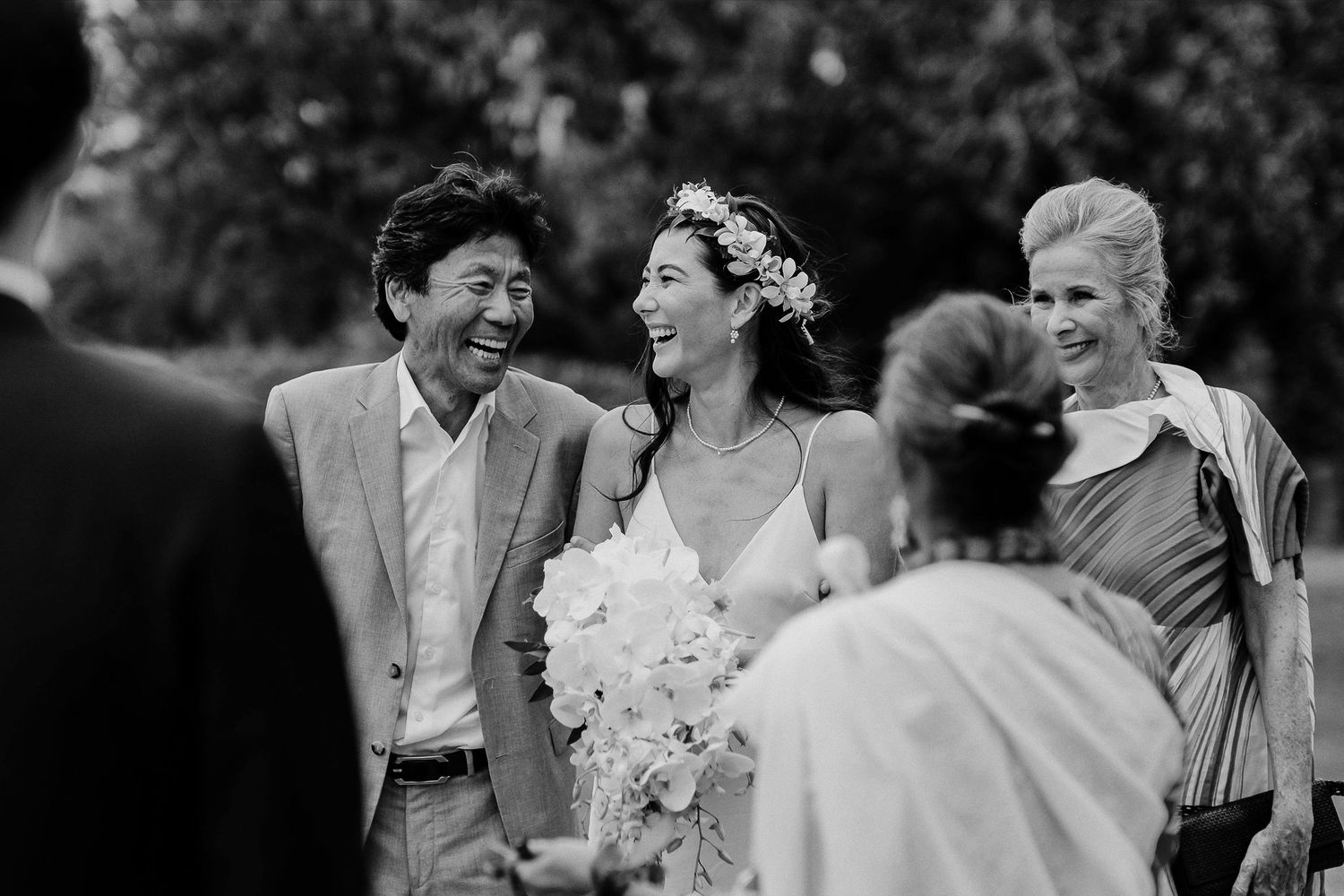 Joyful moment captured in black and white during an outdoor wedding ceremony.