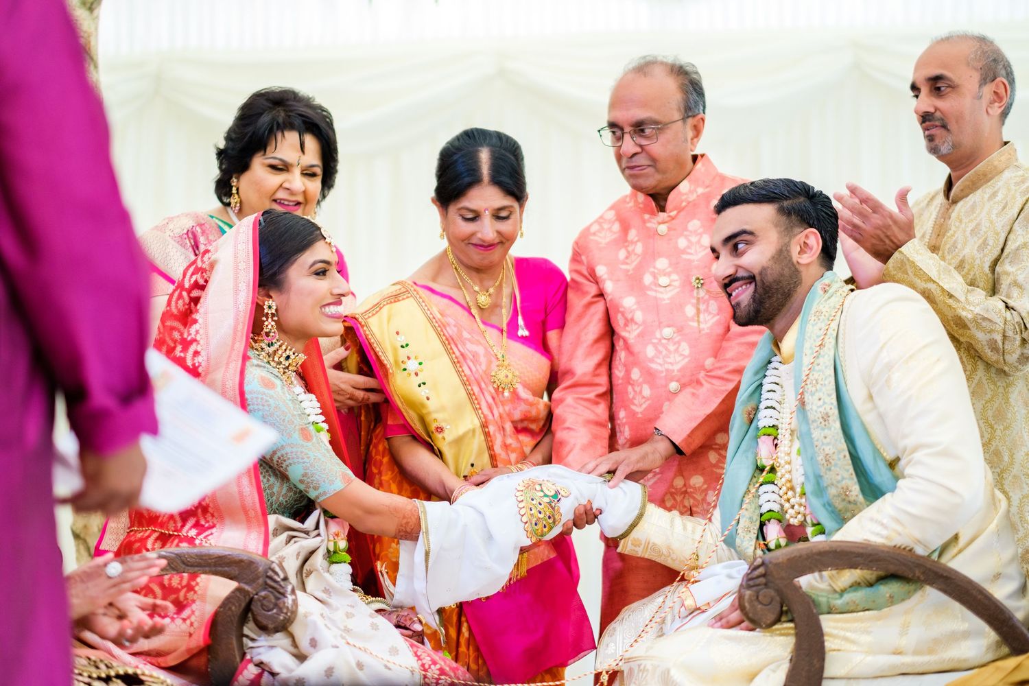 Wedding guests participate in traditional Indian celebration activities with vibrant colors and decorations.