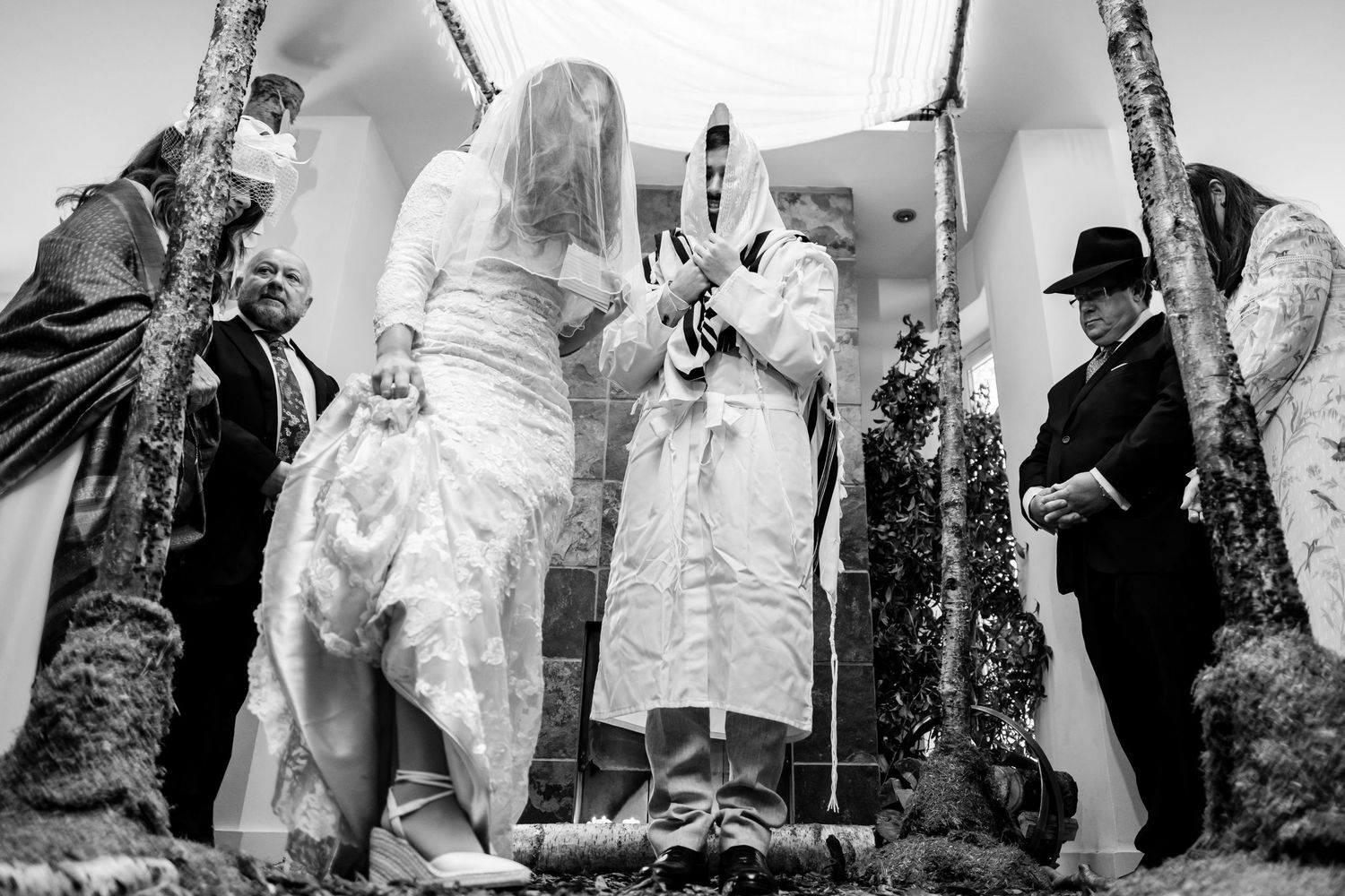 Black and white wedding photography collage showing candid moments of dancing and celebration at a reception.