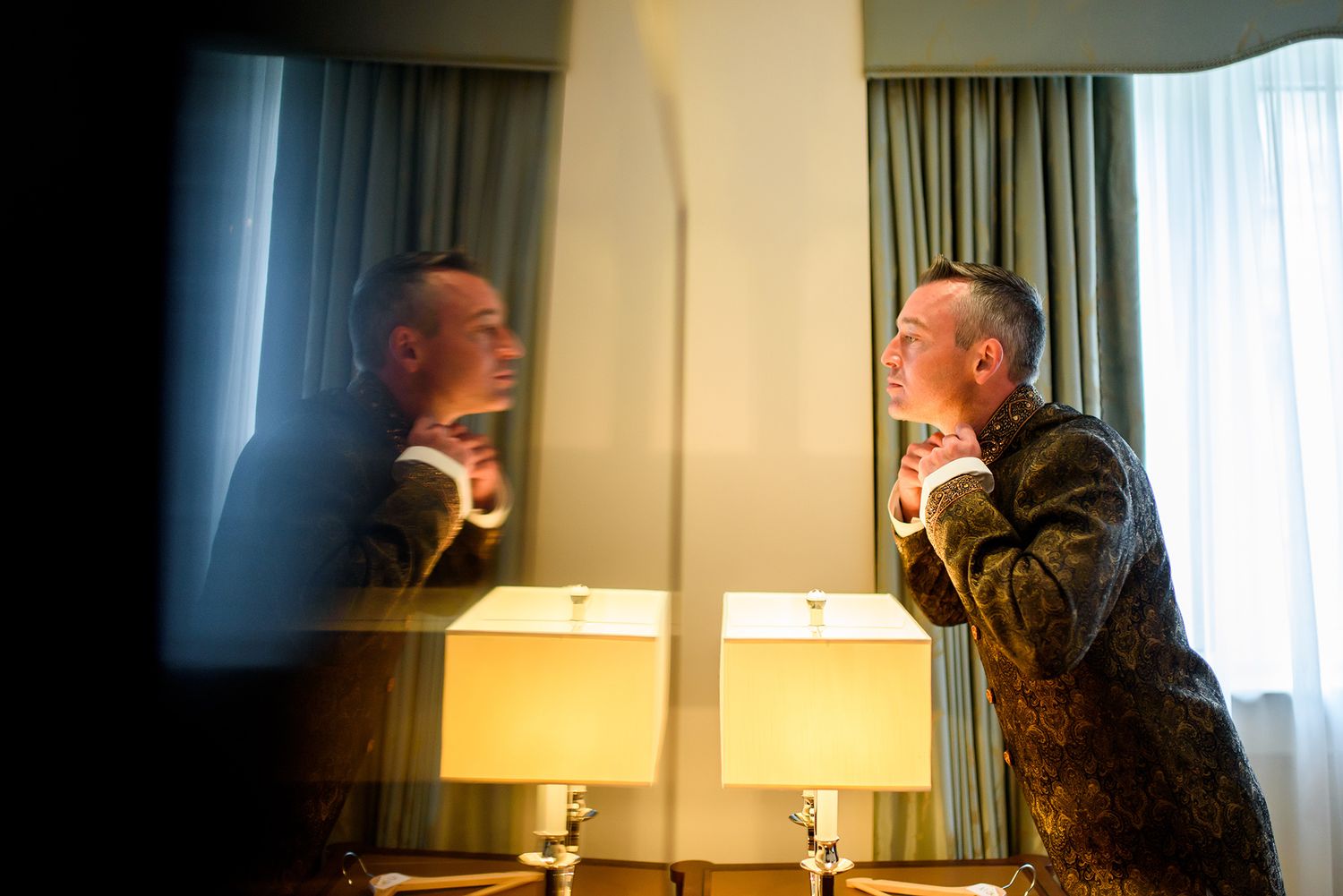 Dramatic hotel room lighting creates artistic shadows and reflections.