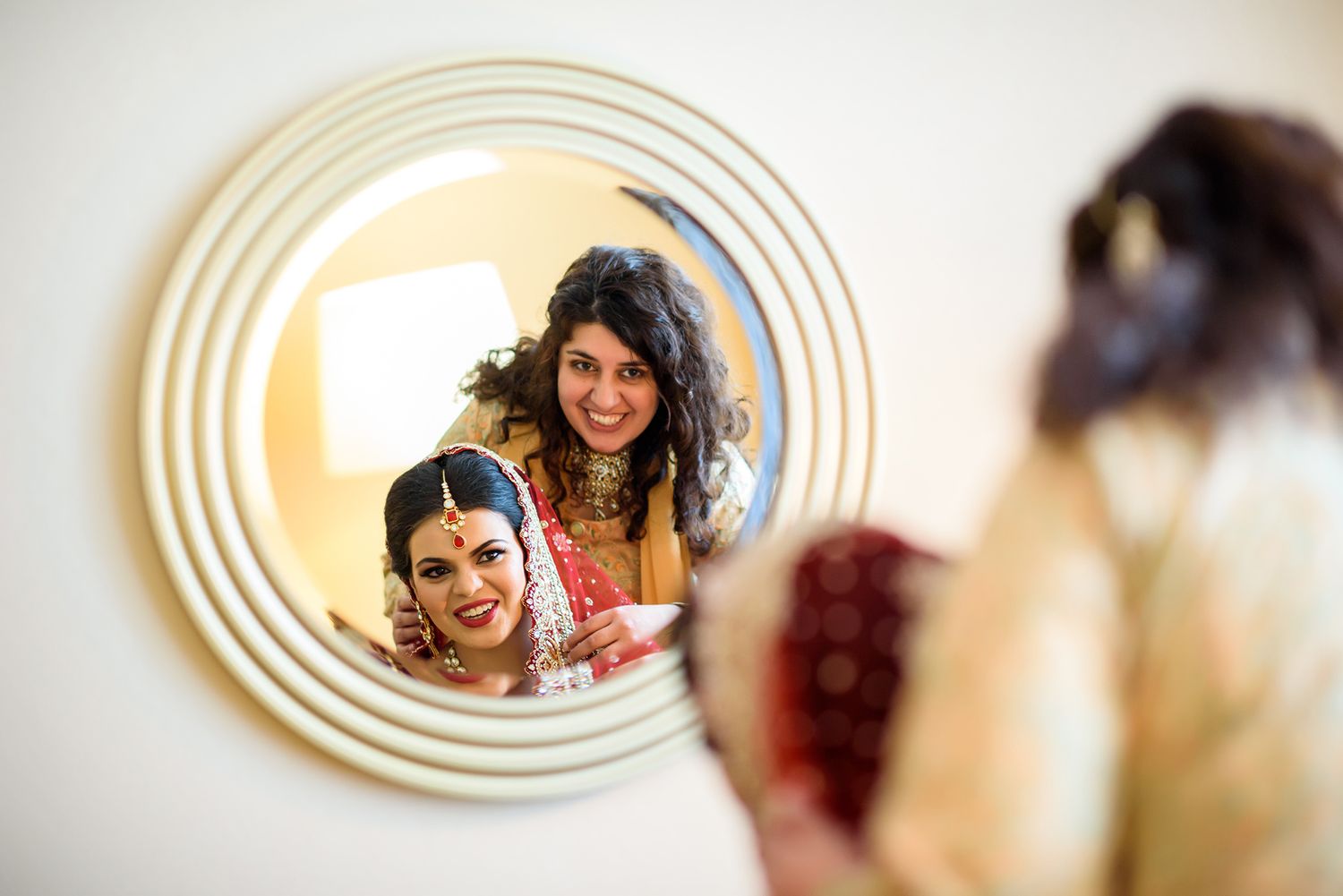 Oval mirror frames create a repeated pattern in interior photography.