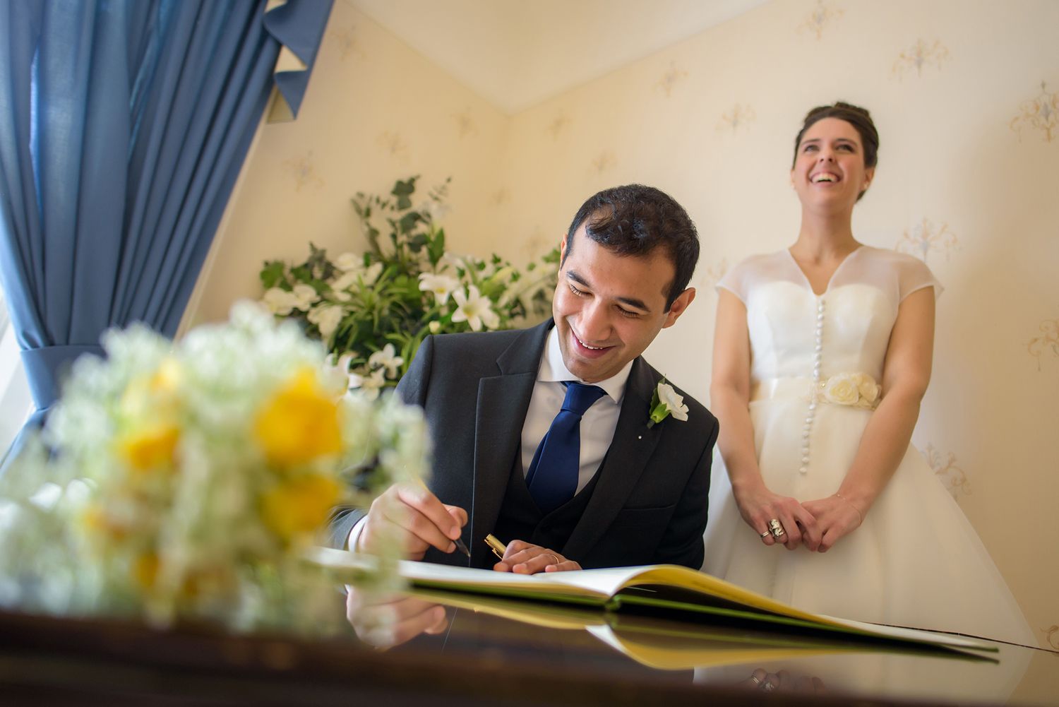 Wedding ceremony signing photos with yellow flowers decorating the table.