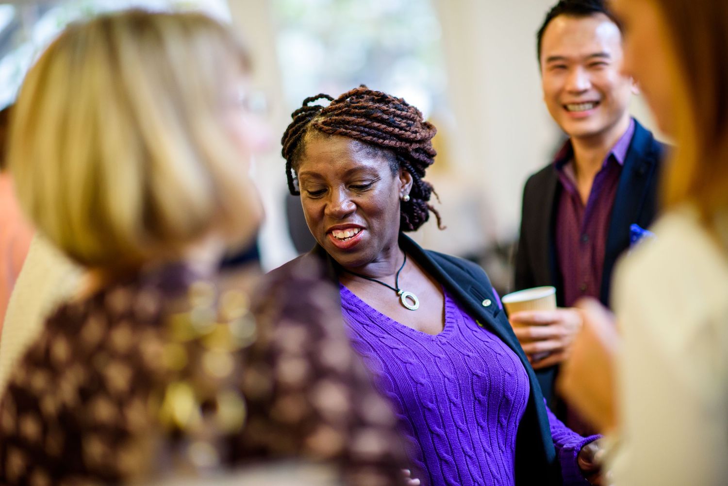 Group of friends enjoying conversation at a social gathering.