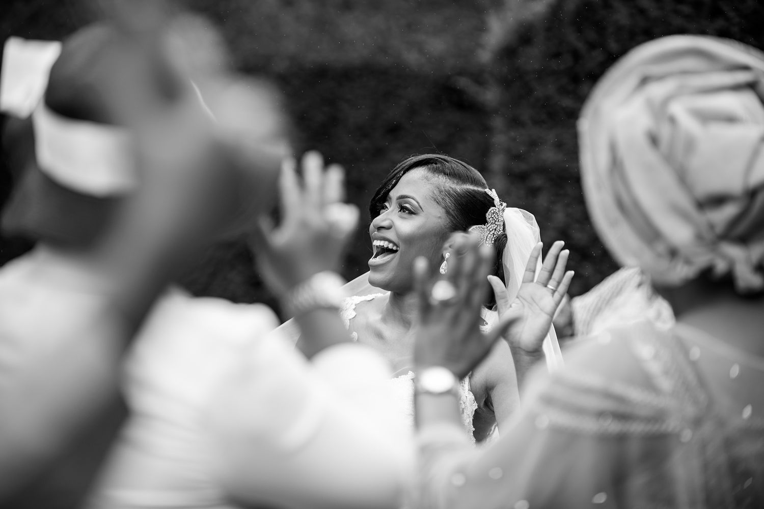 Wedding guests socializing and laughing together during an outdoor celebration event.