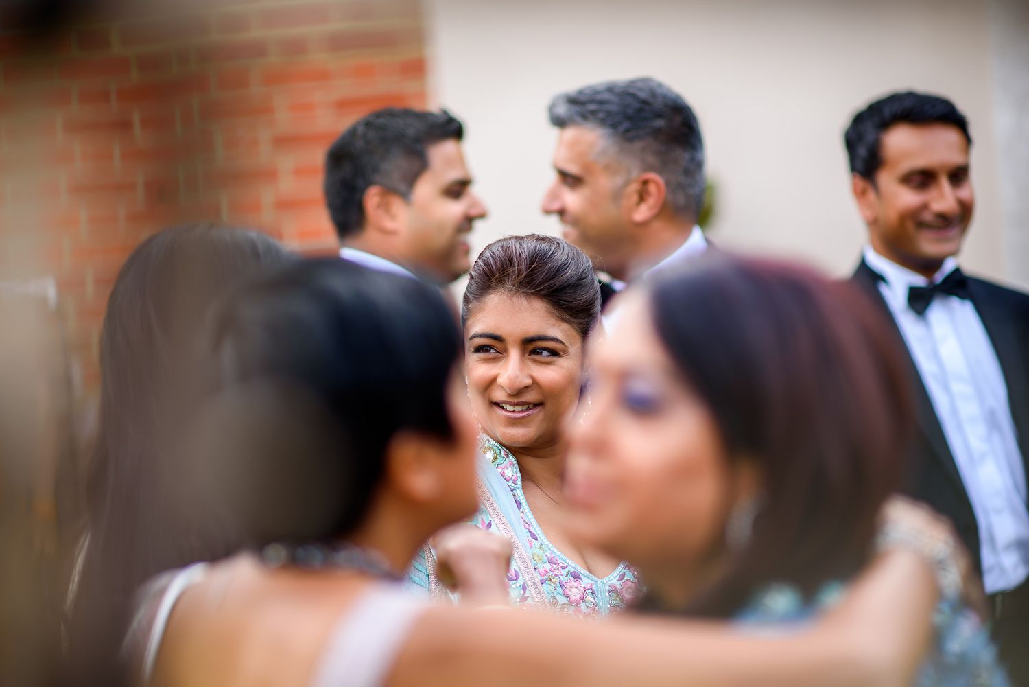 Wedding guests mingling and socializing during the reception festivities.