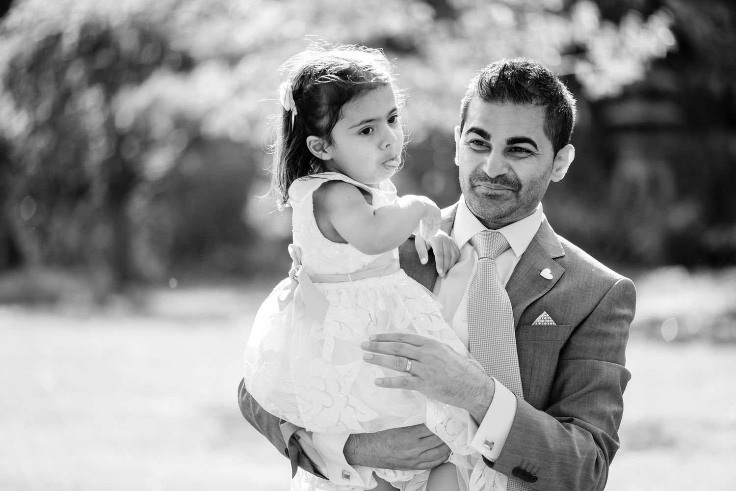 Black and white candid wedding moments captured in sequence outdoors.