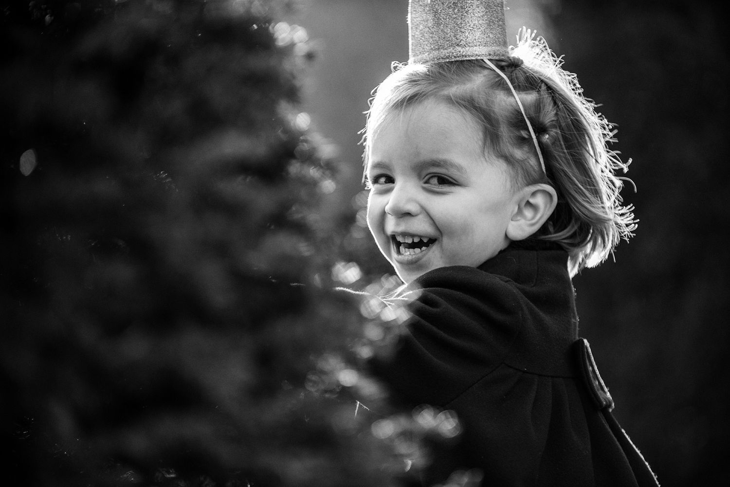 Black and white portrait of a person's joyful expression filled with genuine laughter and delight.