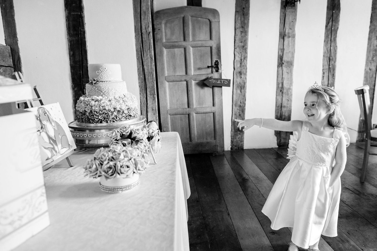 A sequence of black and white photographs showing a person in white clothing walking through a corridor with arched doorways.