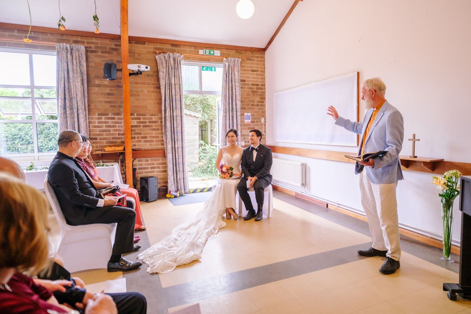 Panoramic view of a bright modern event space with exposed brick walls and large windows.
