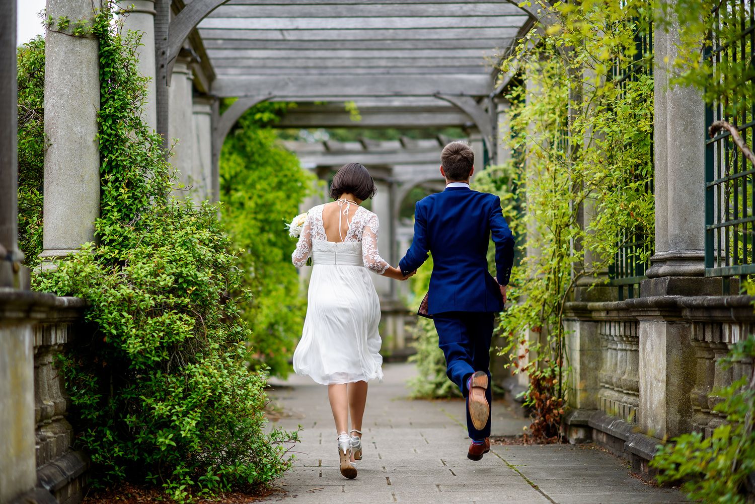 White columns line a scenic garden walkway with natural light streaming through overhead.
