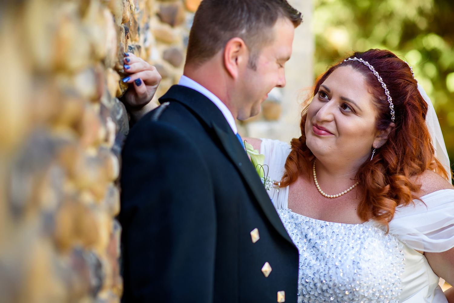 Tender wedding portrait showing a close intimate moment outdoors.