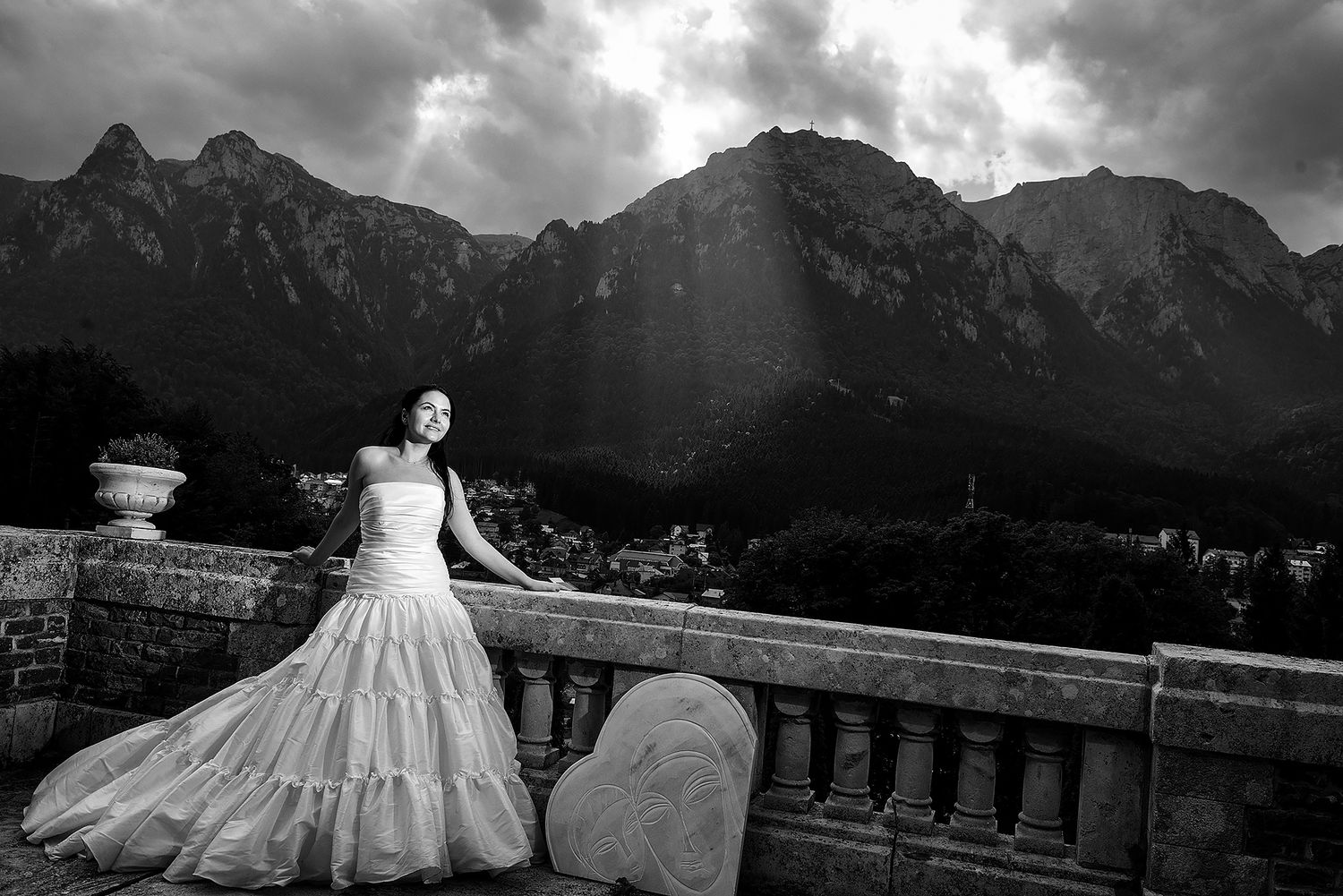 Dramatic wedding portraits with mountainous backdrop and moody storm clouds.