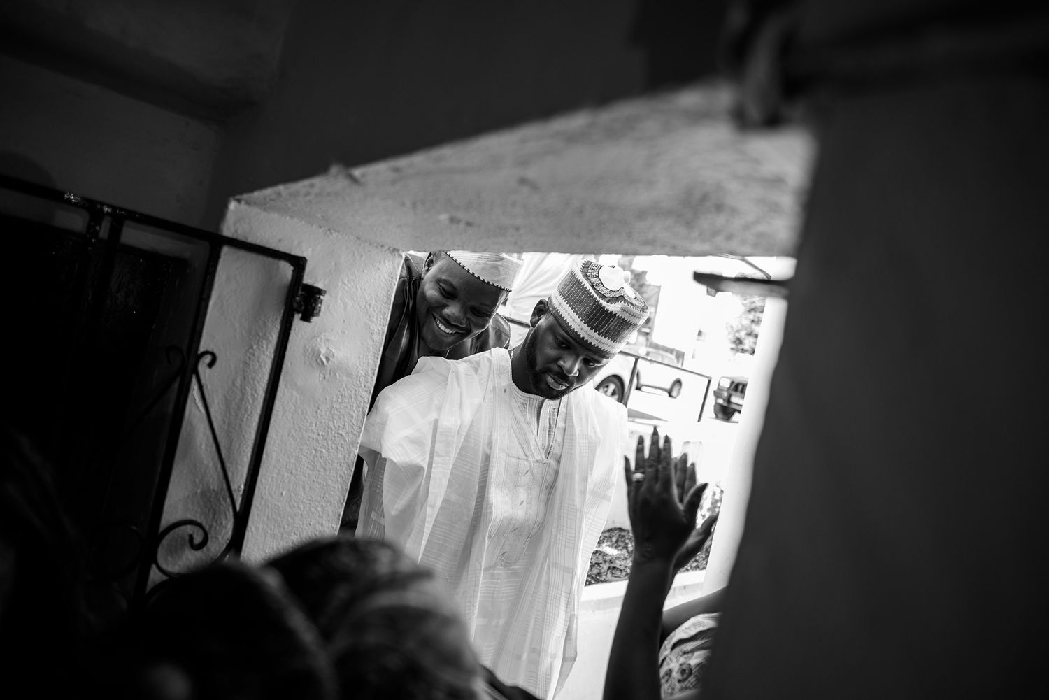 Black and white image of people gathered in a dimly lit space.