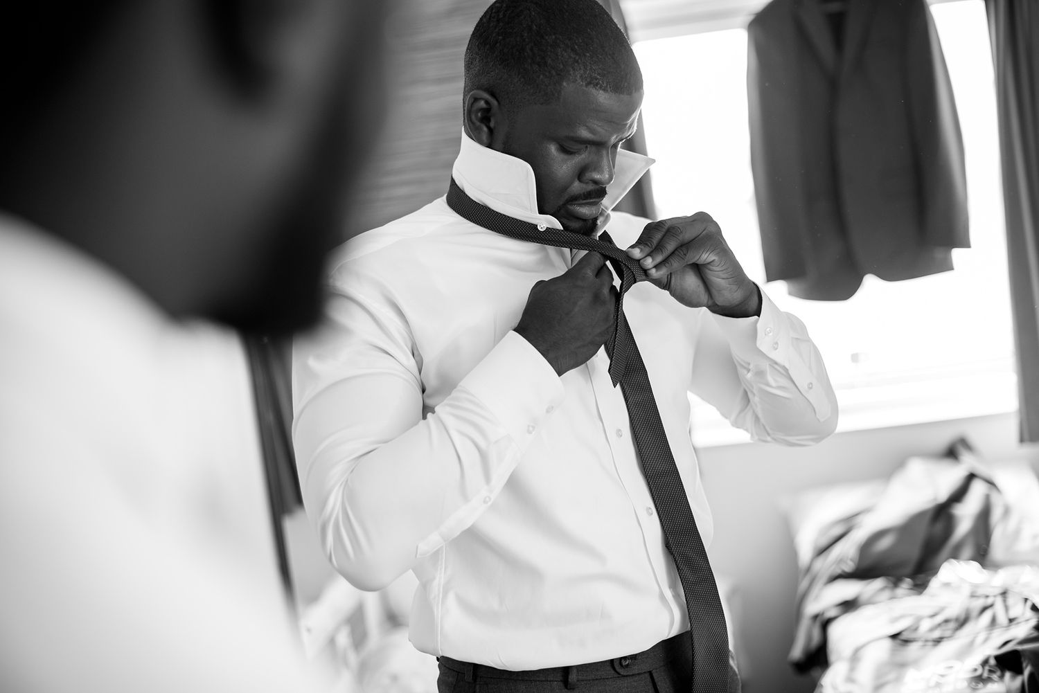 Wedding preparations shown in elegant black and white photography.