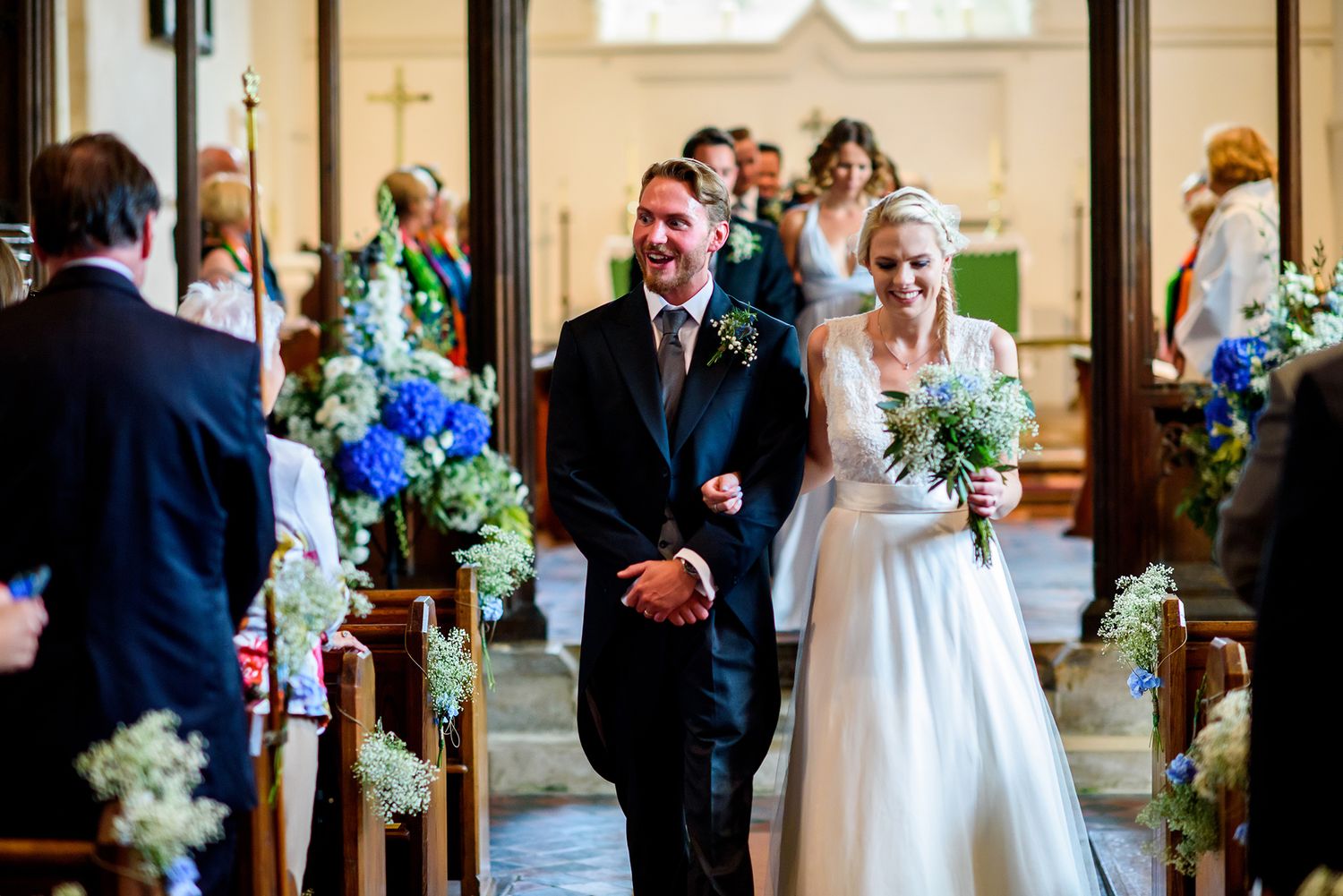Beautiful stone church interior decorated with floral arrangements for a wedding ceremony.