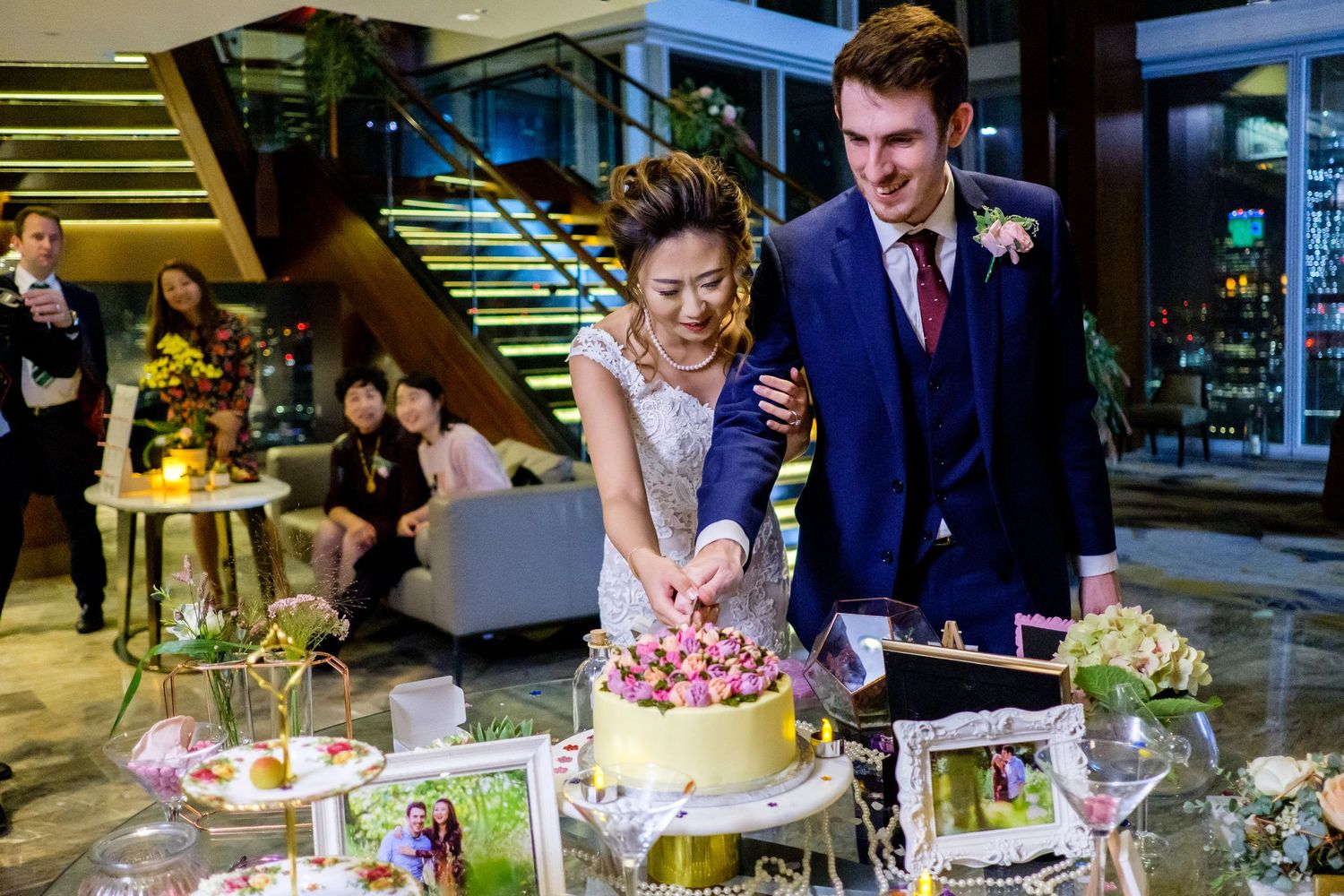 Wedding reception dessert table with elegant cake and decorative treats.