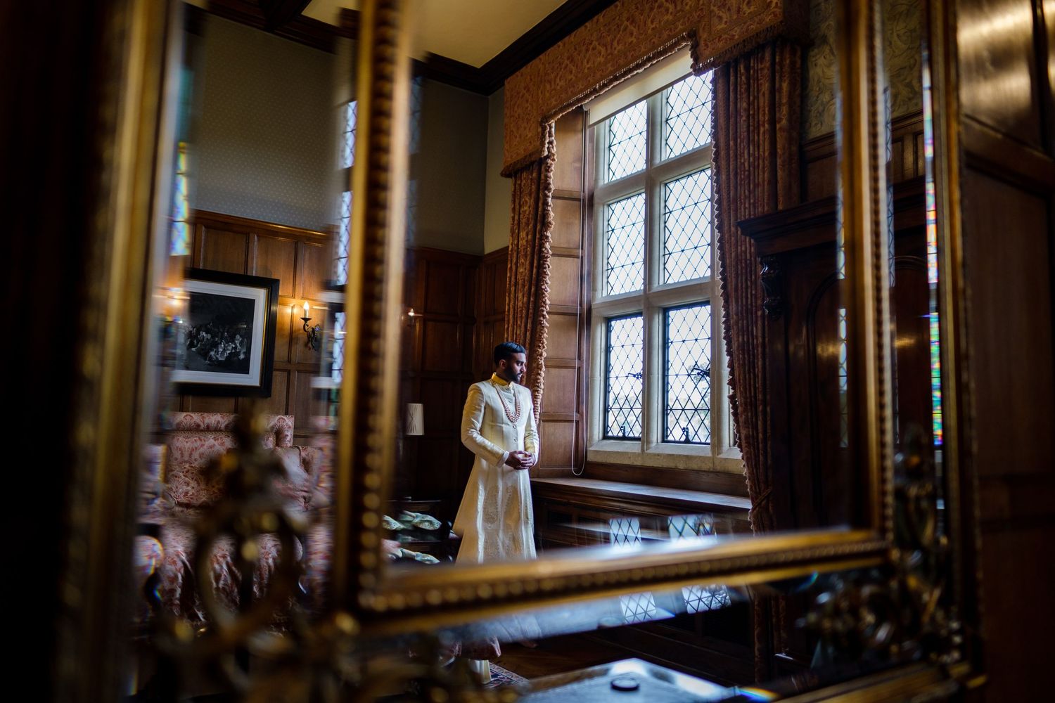 Series of vintage windows and archways in traditional manor house interior with natural lighting.