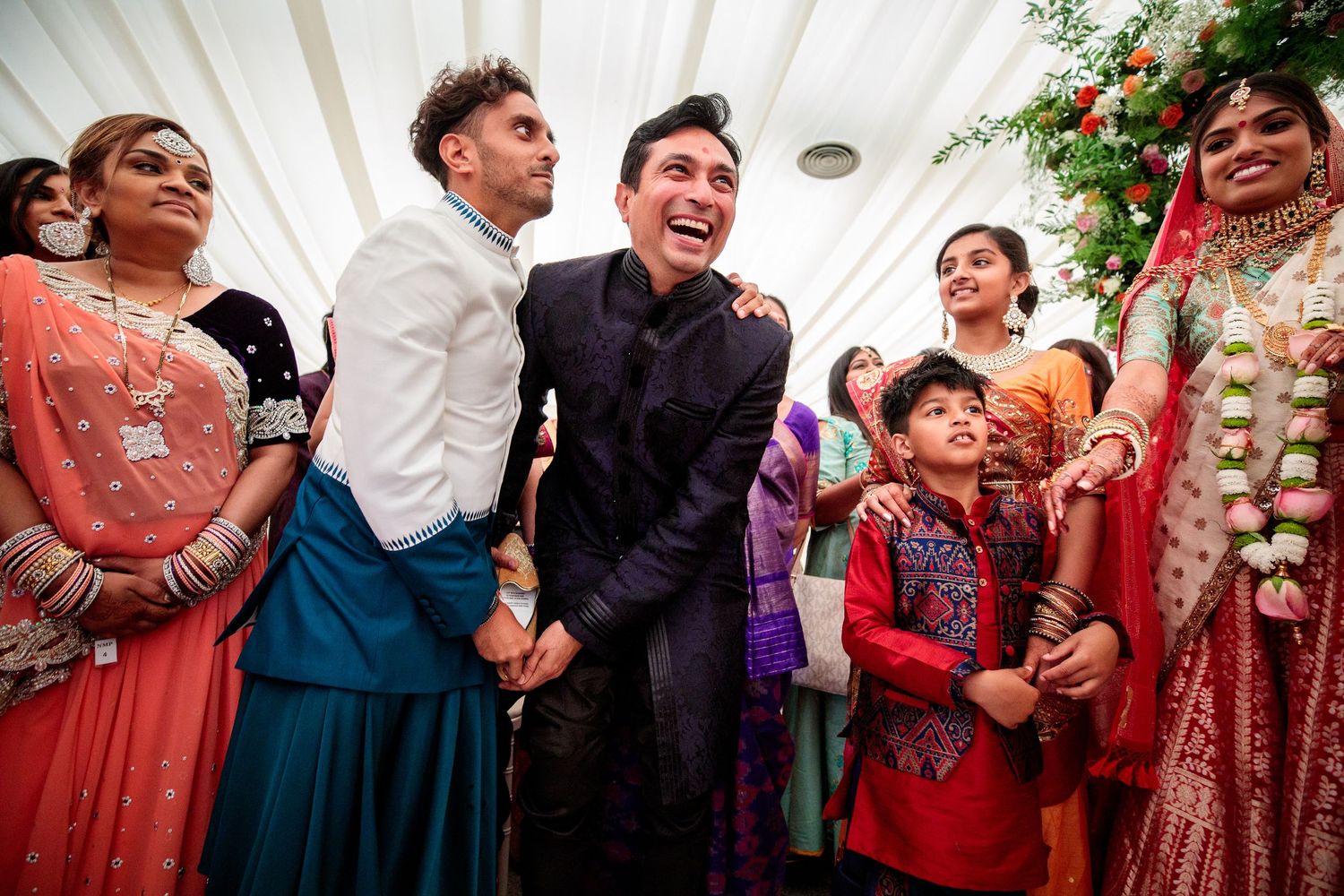 Wedding reception celebration with guests in colorful attire enjoying festivities.