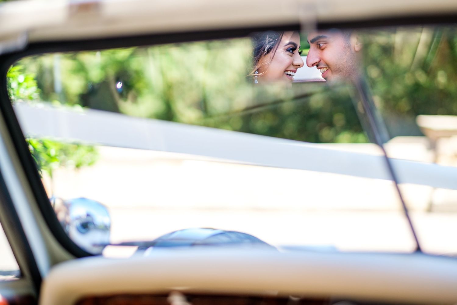White luxury vehicles parked in line for wedding transportation.