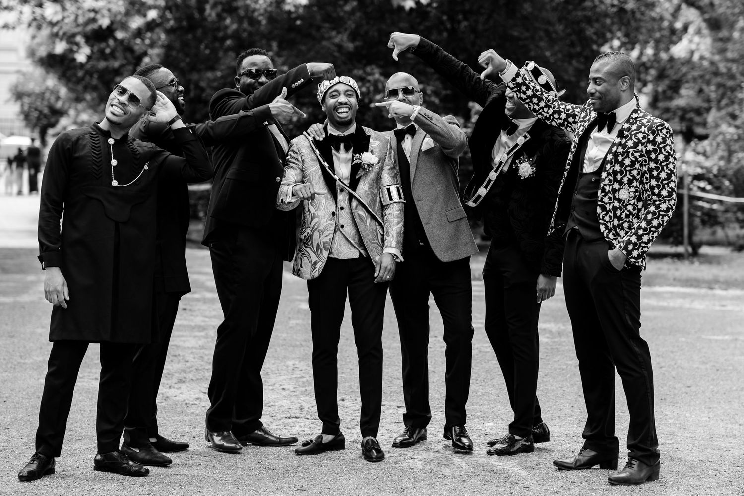 A black and white photo of a group of friends drinking together outdoors.