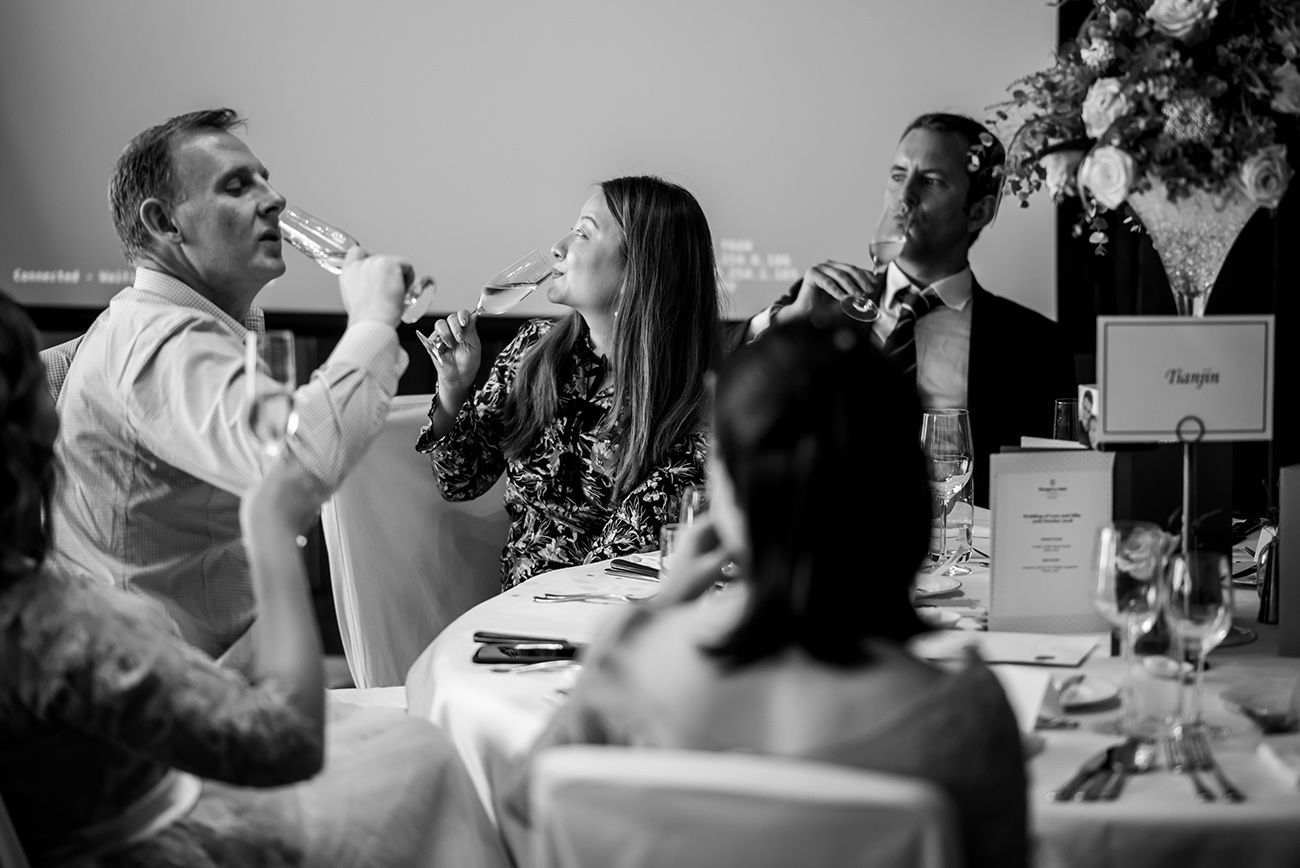 Black and white candid shots of people dining at a formal event.