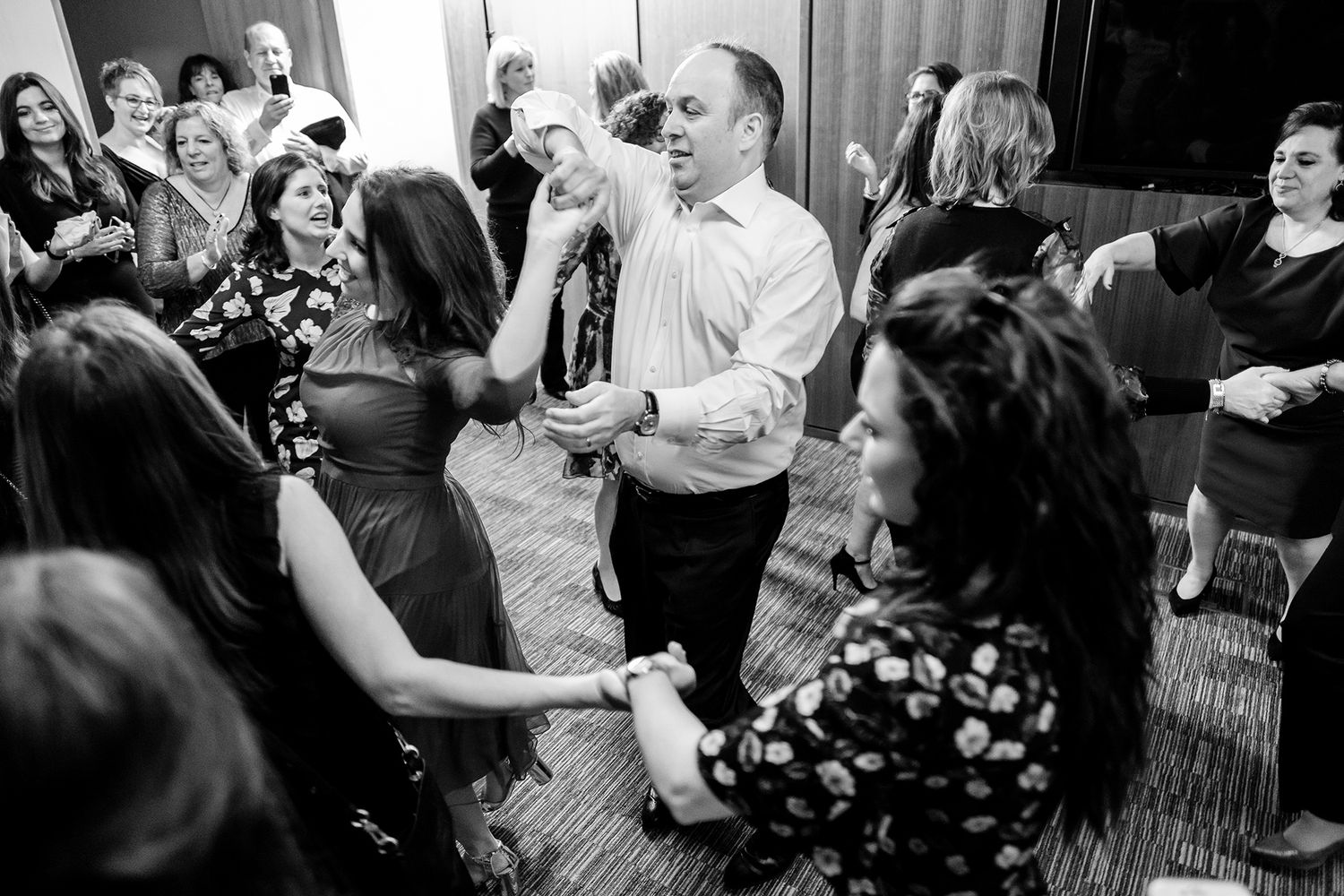 Energetic party scene with guests dancing and socializing in a beautifully decorated venue.