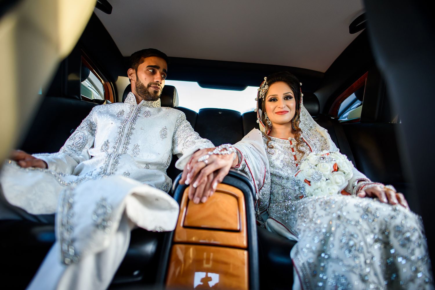 Intimate wedding car moments captured through artistic photography.