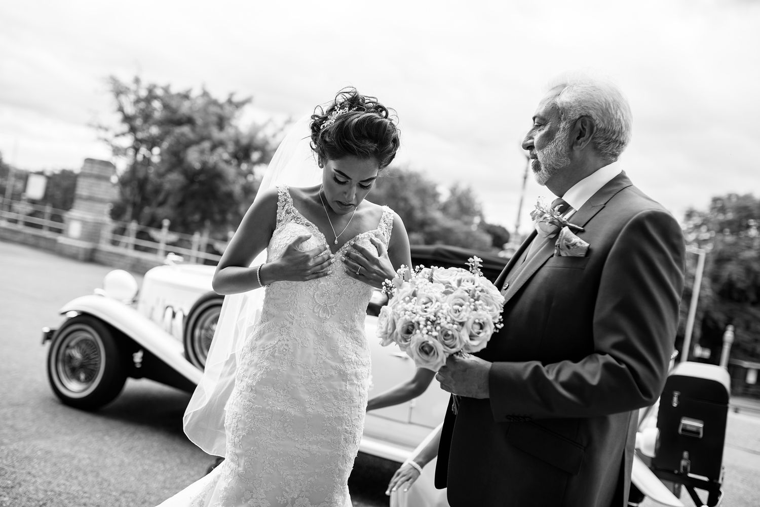 A couple shares their first dance moment on the dance floor surrounded by elegant black and white decor.