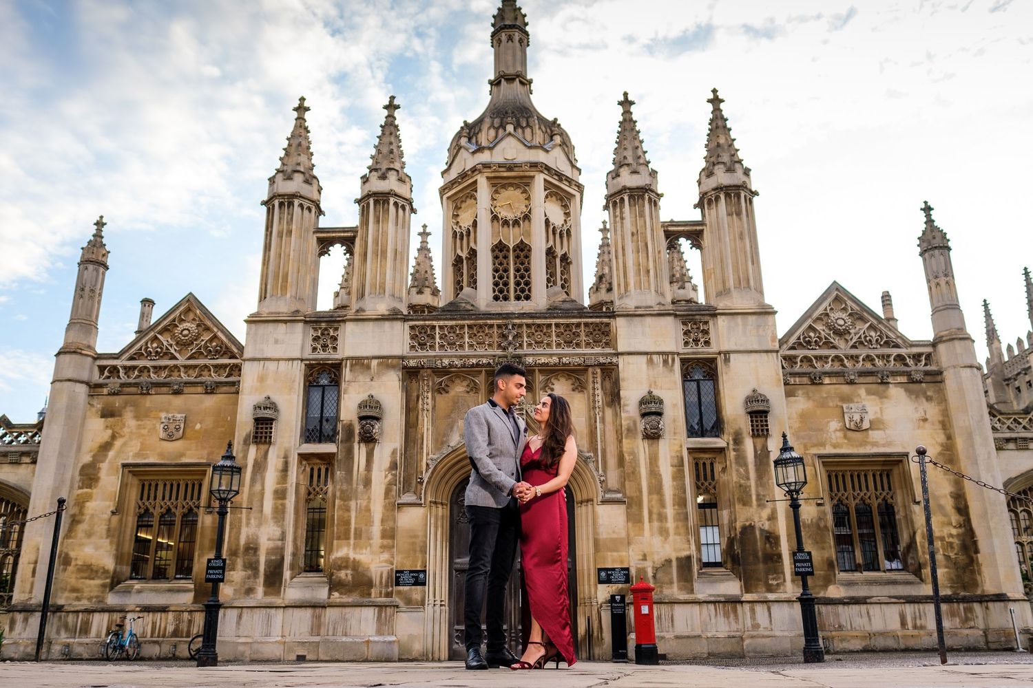 Historic Gothic architecture and spires of King's College Chapel in Cambridge against a dramatic cloudy sky.