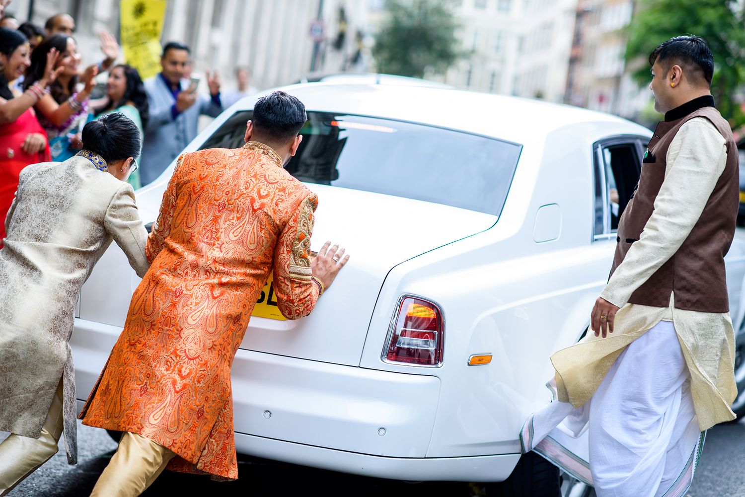 White luxury wedding car with traditional Indian wedding decorations.