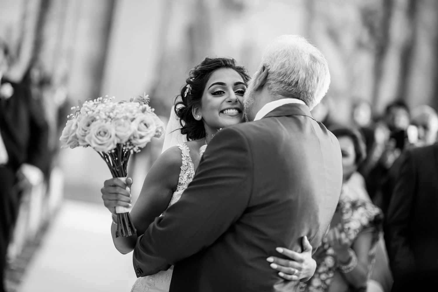 Tender embraces and joyful reactions during outdoor wedding reception.