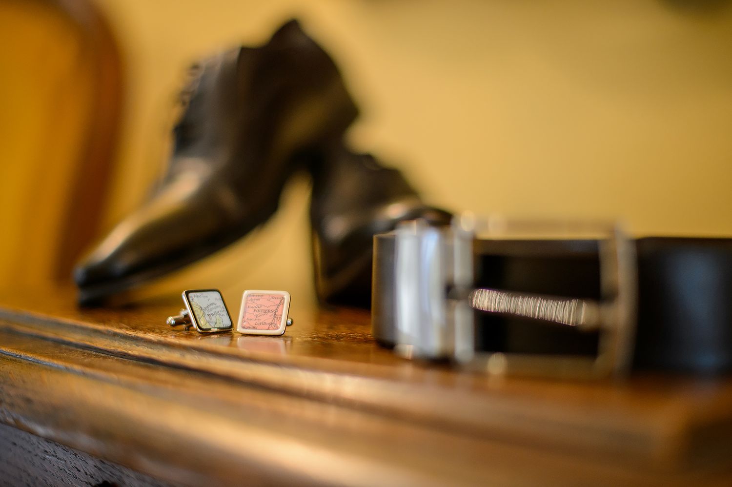 Shallow depth of field detail shot of wooden furniture in warm ambient lighting.