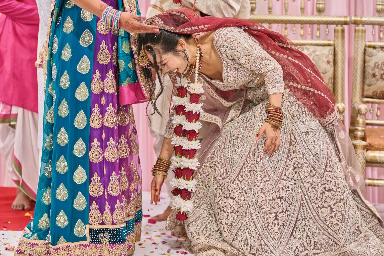 Traditional Indian wedding ritual with decorative garlands and ornate attire.