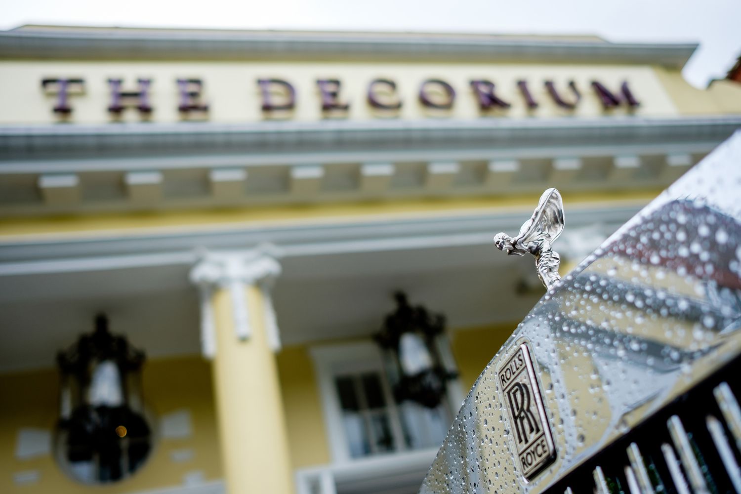 The Decoirum building sign with sparkly wedding shoe detail in foreground.