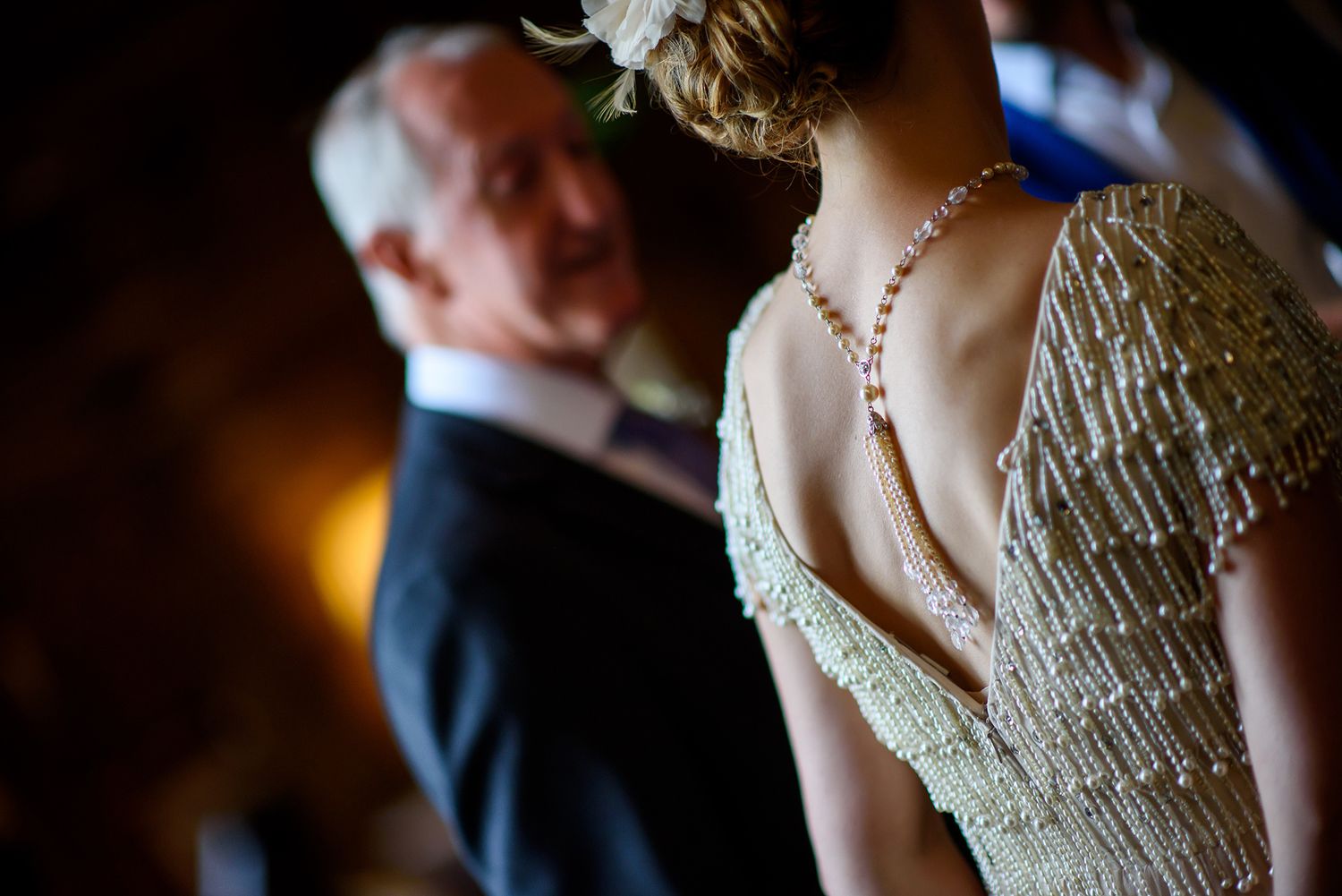Detail shot of ornate beaded dress back at formal event.
