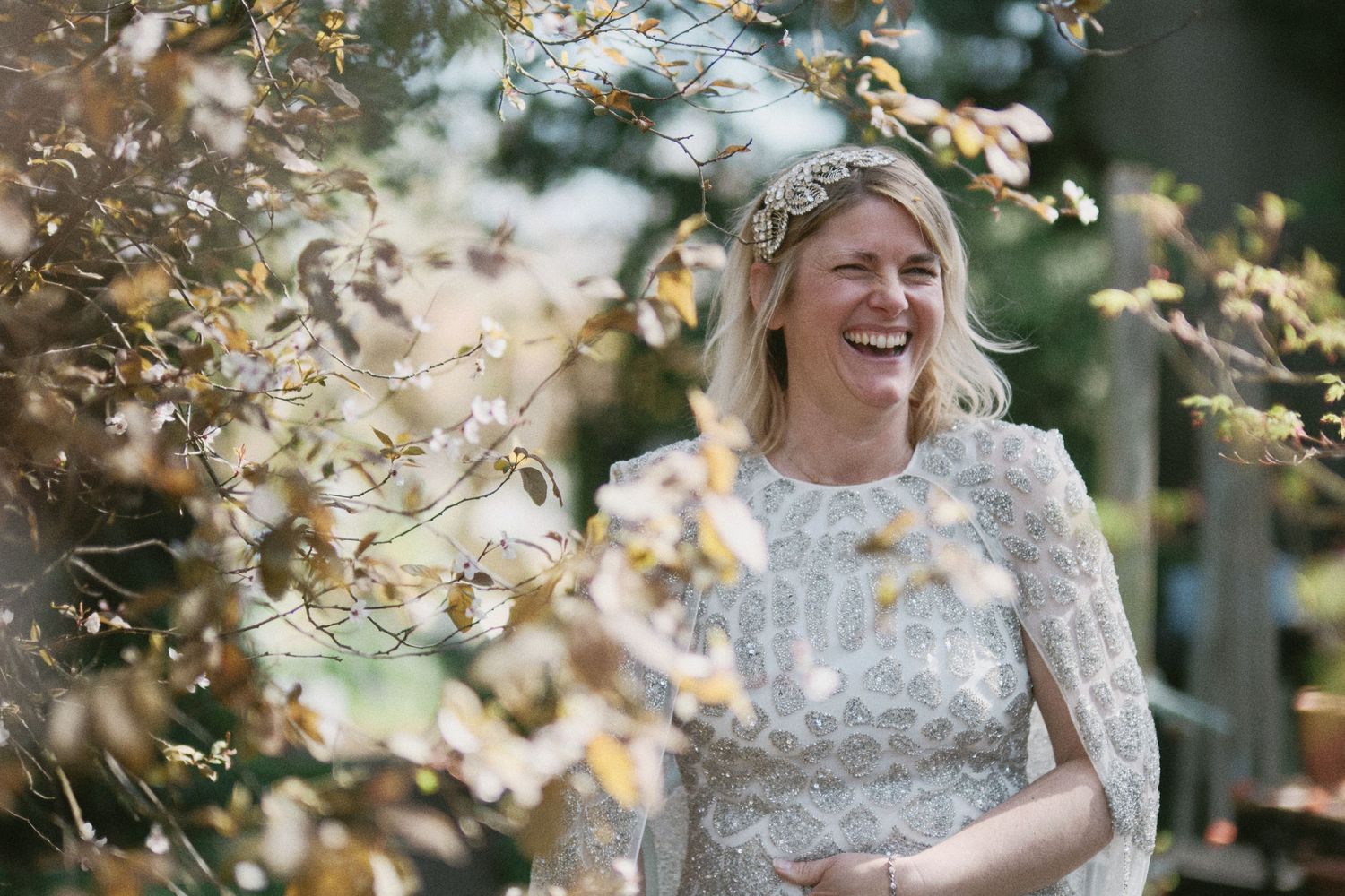 Celebratory moment under golden sunlight with delicate lace dress details.
