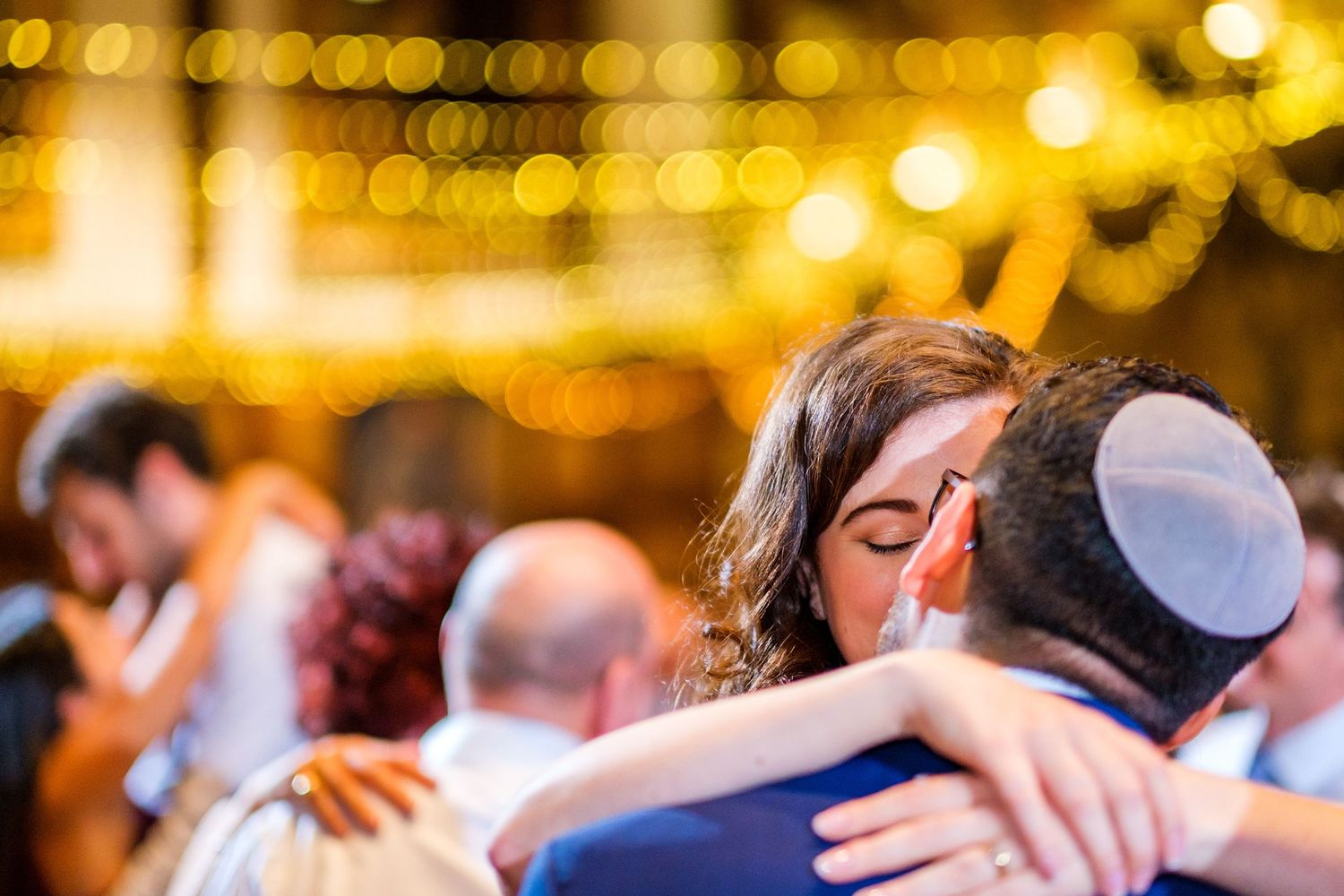 Wedding reception dance floor with warm golden lighting and festive atmosphere.