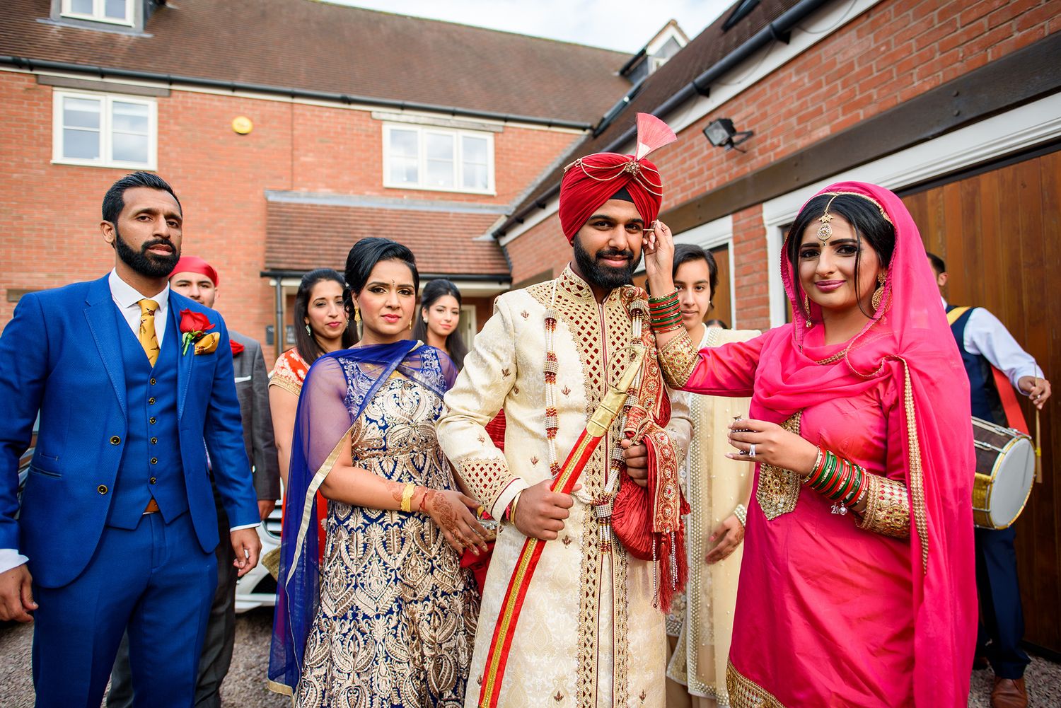 Wedding celebration gathering showing guests in colorful traditional Indian formal wear.