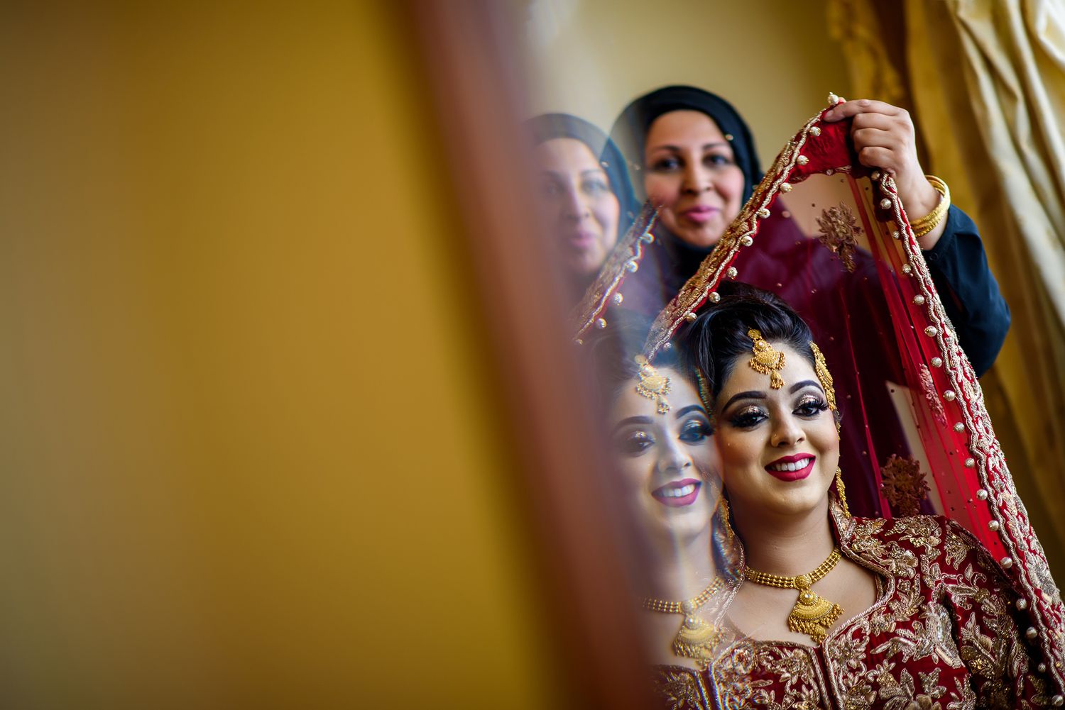 Traditional bridal preparation scene with ornate red and gold details.