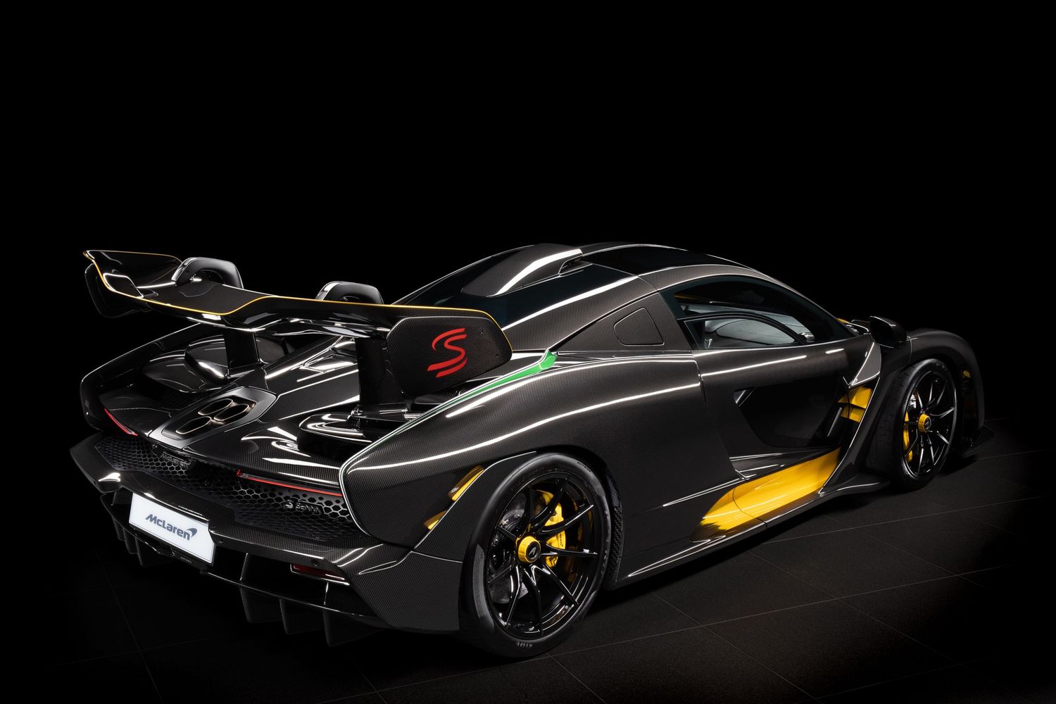 Sleek black supercar with aggressive aerodynamic styling and yellow accents shown from multiple dramatic angles.